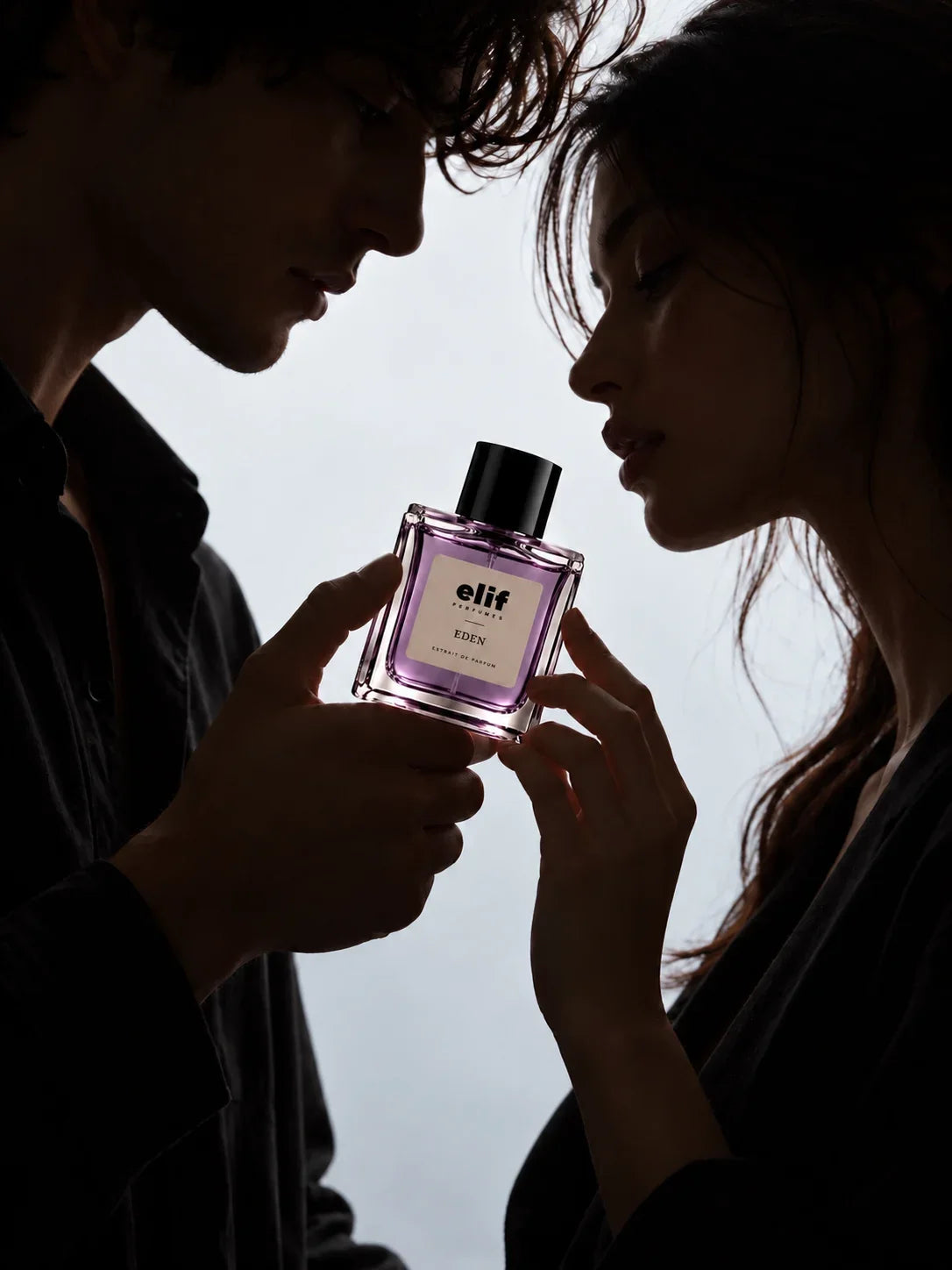 Elif Eden long-lasting perfume bottle held between a man and woman in an intimate, romantic setting, highlighting the elegant purple fragrance bottle and extrait de parfum presentation.