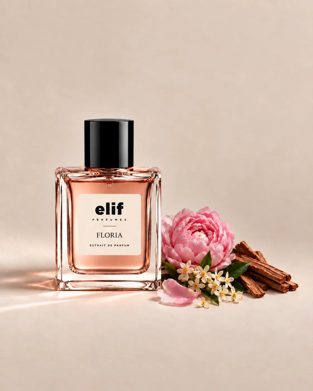 Elif Floria long-lasting perfume bottle with soft pink floral fragrance, peony, delicate white flowers, green leaves, and warm woody accents, presented in an elegant extrait de parfum bottle on a neutral background.