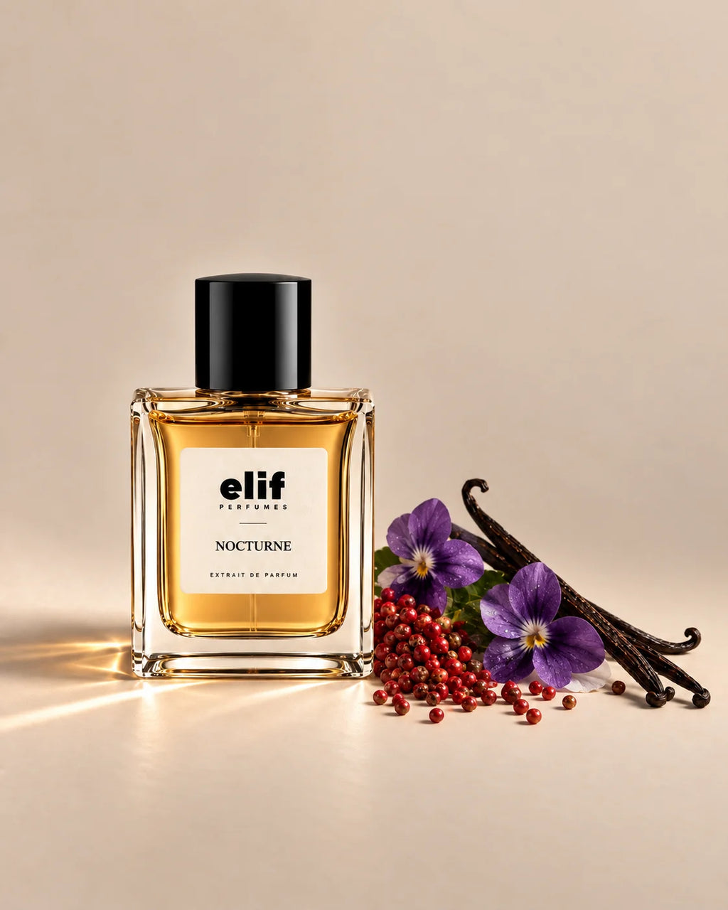 Elif Nocturne perfume bottle filled with warm amber-gold liquid and topped with a glossy black cap, displayed against a warm beige background. Purple violet flowers, red berries, and dark vanilla pods are arranged beside the bottle, with warm directional lighting and subtle shadows.