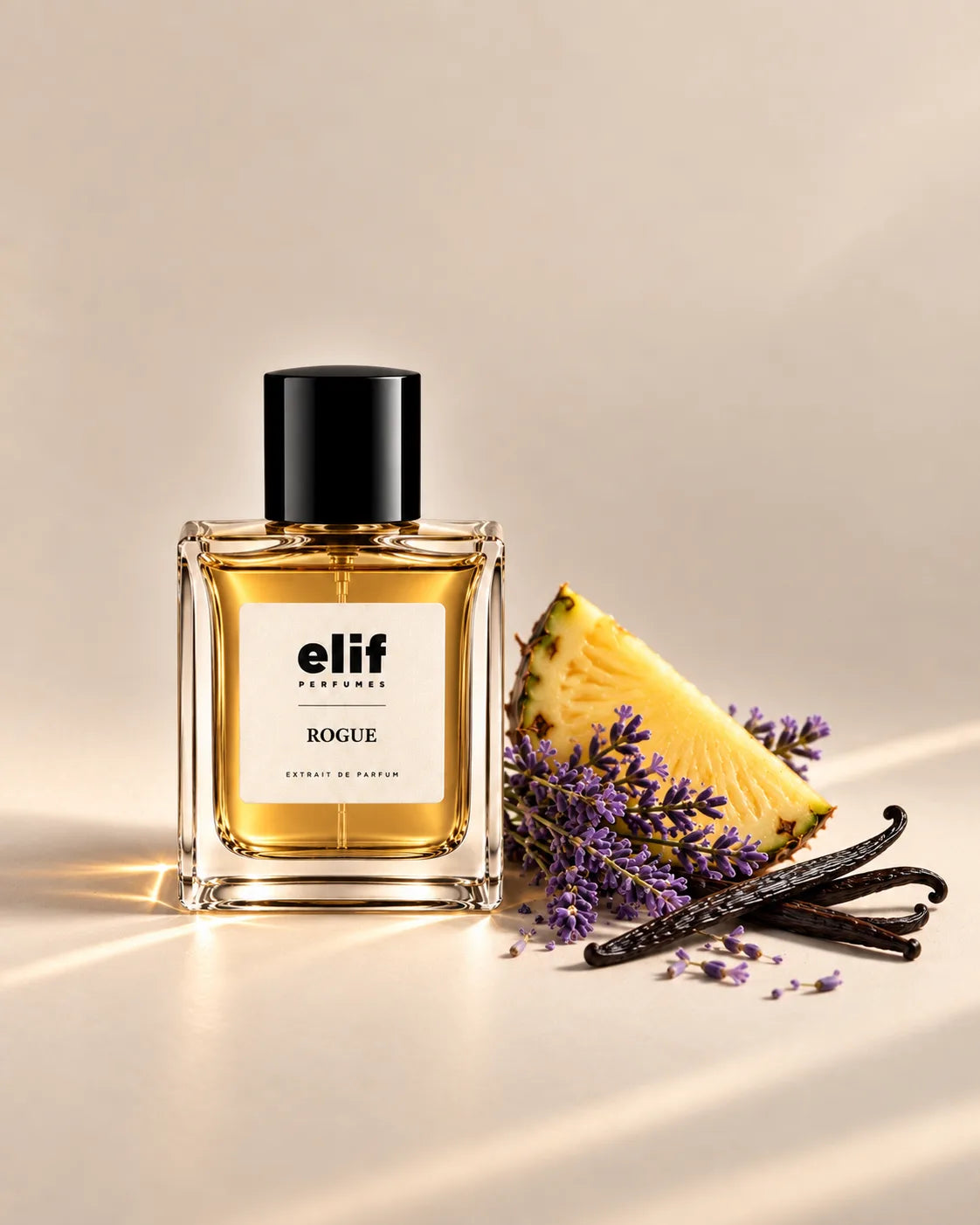 Elif Rogue perfume bottle filled with warm golden liquid and topped with a glossy black cap, displayed against a warm beige background. A fresh pineapple slice, purple lavender flowers, and dark vanilla pods are arranged beside the bottle, with warm directional lighting and subtle shadows. A long-lasting fragrance with a rich, aromatic character.